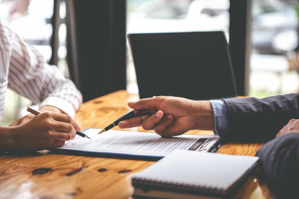 business people negotiating contracts with documents on the table